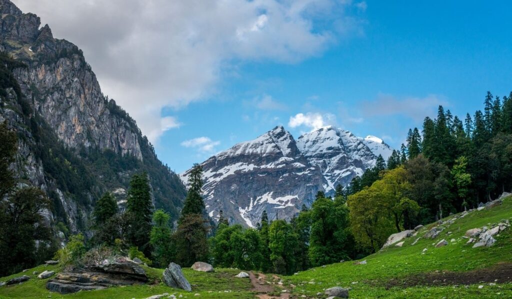 A hiker enjoying a mountaintop view, embracing the joy of trekking.