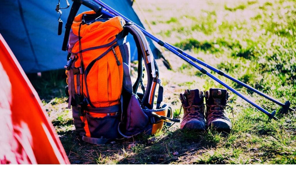 Trekking,  Hiker checking her backpack and equipment before starting a trek.