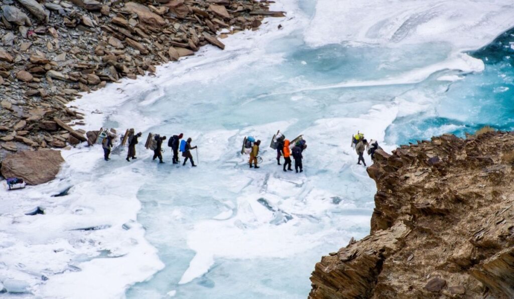 a photo of chadar trek, : Frozen Zanskar River with trekkers walking on its icy surface.