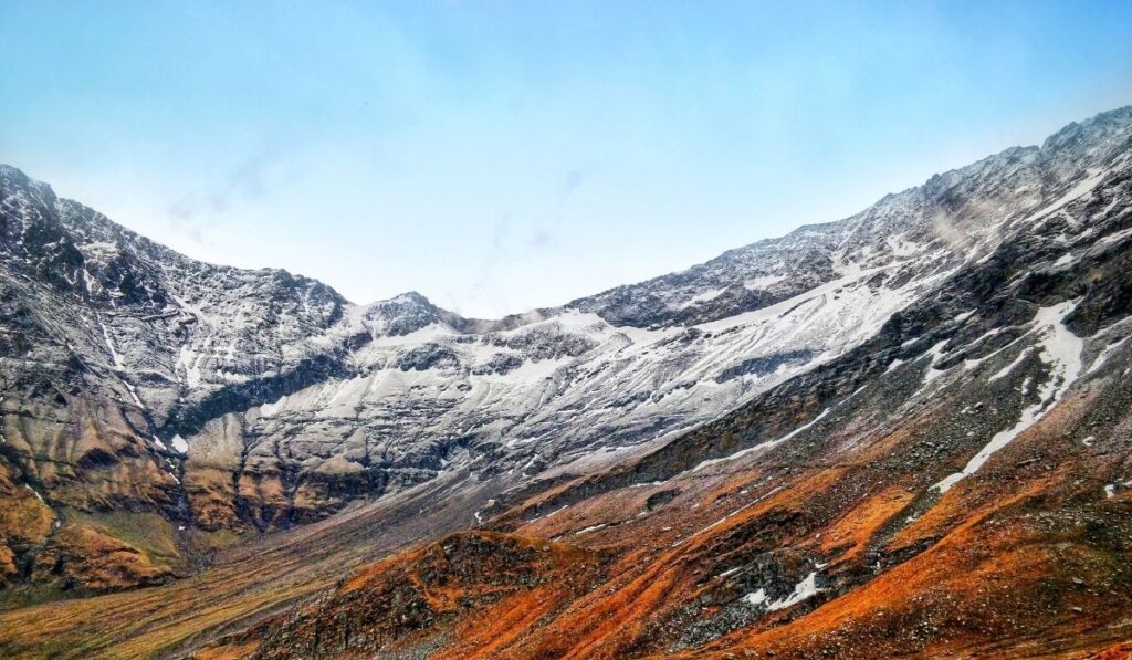 Roopkund, High-altitude Roopkund Lake with surrounding snow-capped mountains.