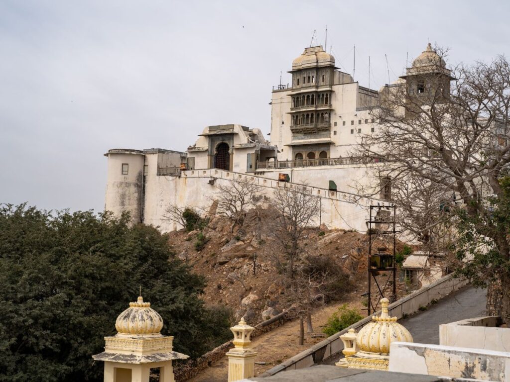 Elevated view of Monsoon Palace with cityscape of Udaipur in the background