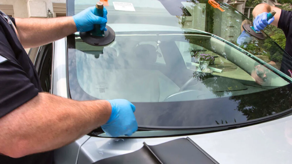 Windshield Repair: Skilled technicians installing or repairing a car windshield with precision.