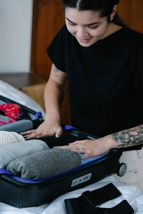 hotel check-in time: Lady packing for travel and checking for safety - pexels photo 